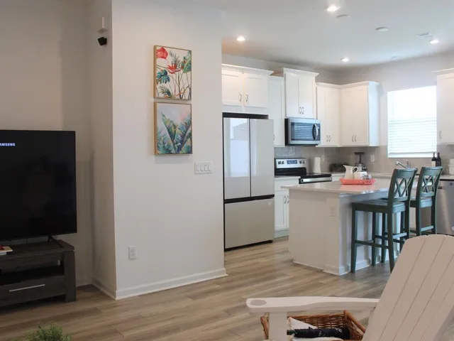 a kitchen with refrigerator cabinets and wooden floor