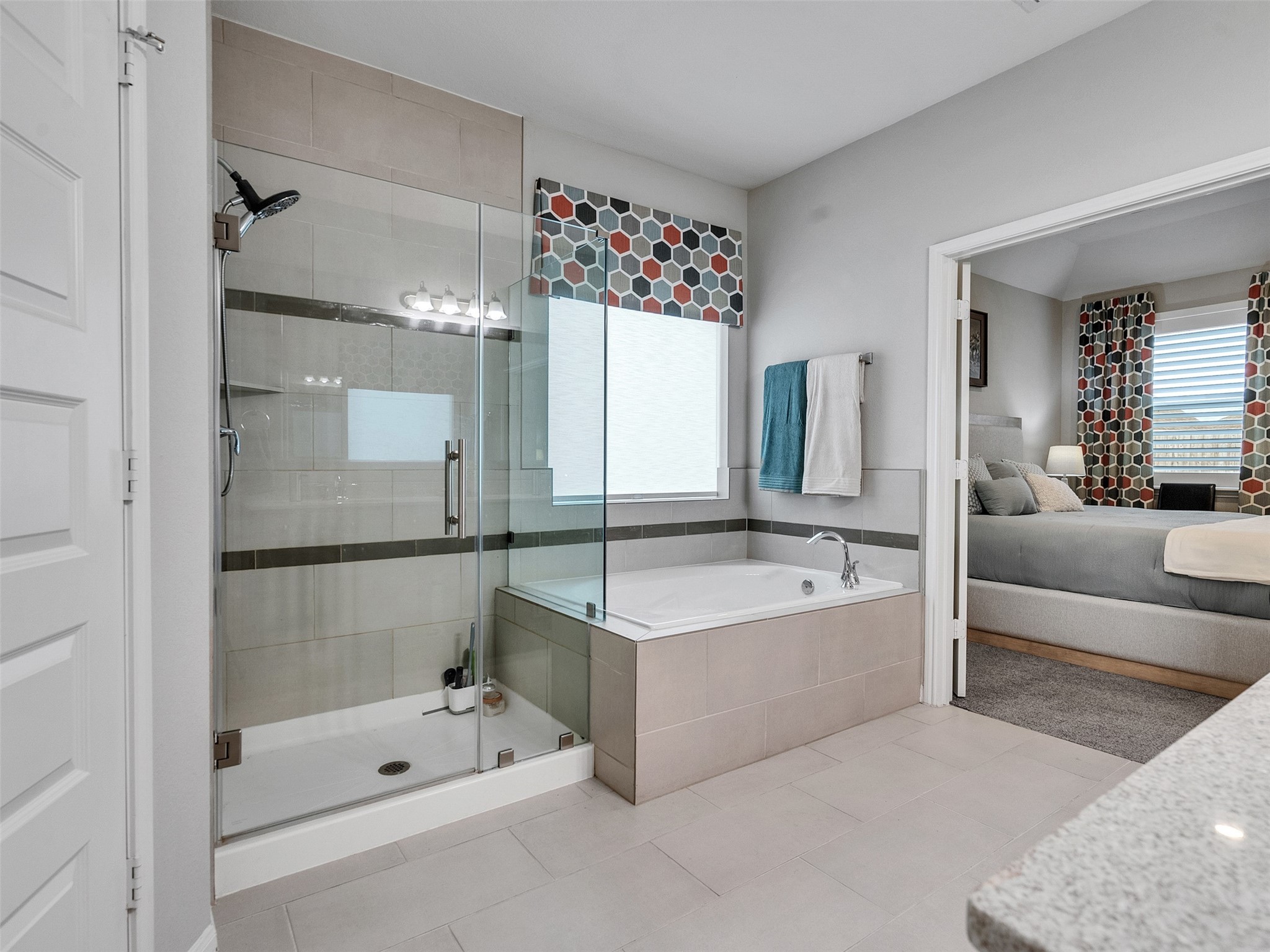 1841 Alyssa Way Alvin, TX 77511 - Photo 42 of 48 a bathroom with a tub a double vanity sink and a mirror