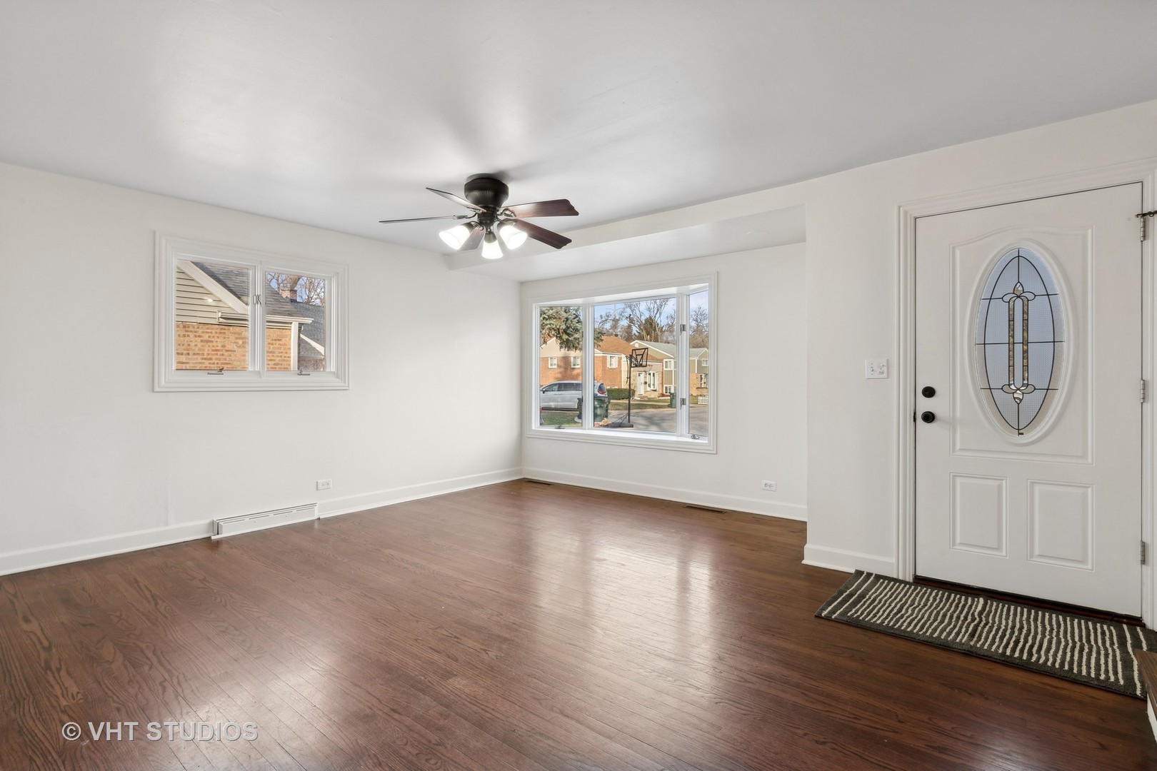 601 Long Road Glenview, IL 60025 - Photo 3 of 27 a view of an empty room with wooden floor and a ceiling fan