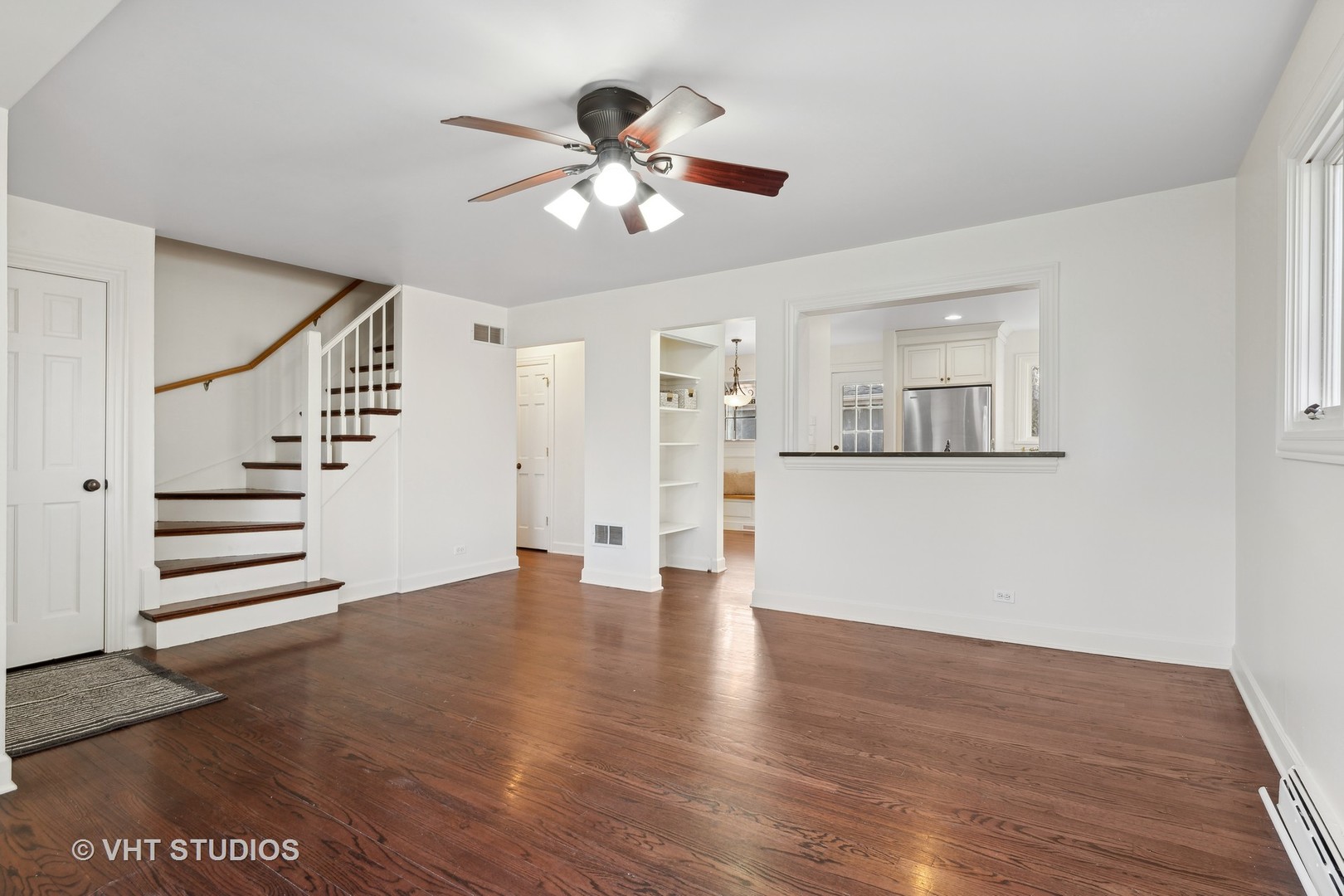 601 Long Road Glenview, IL 60025 - Photo 5 of 27 a view of an empty room with wooden floor and a ceiling fan