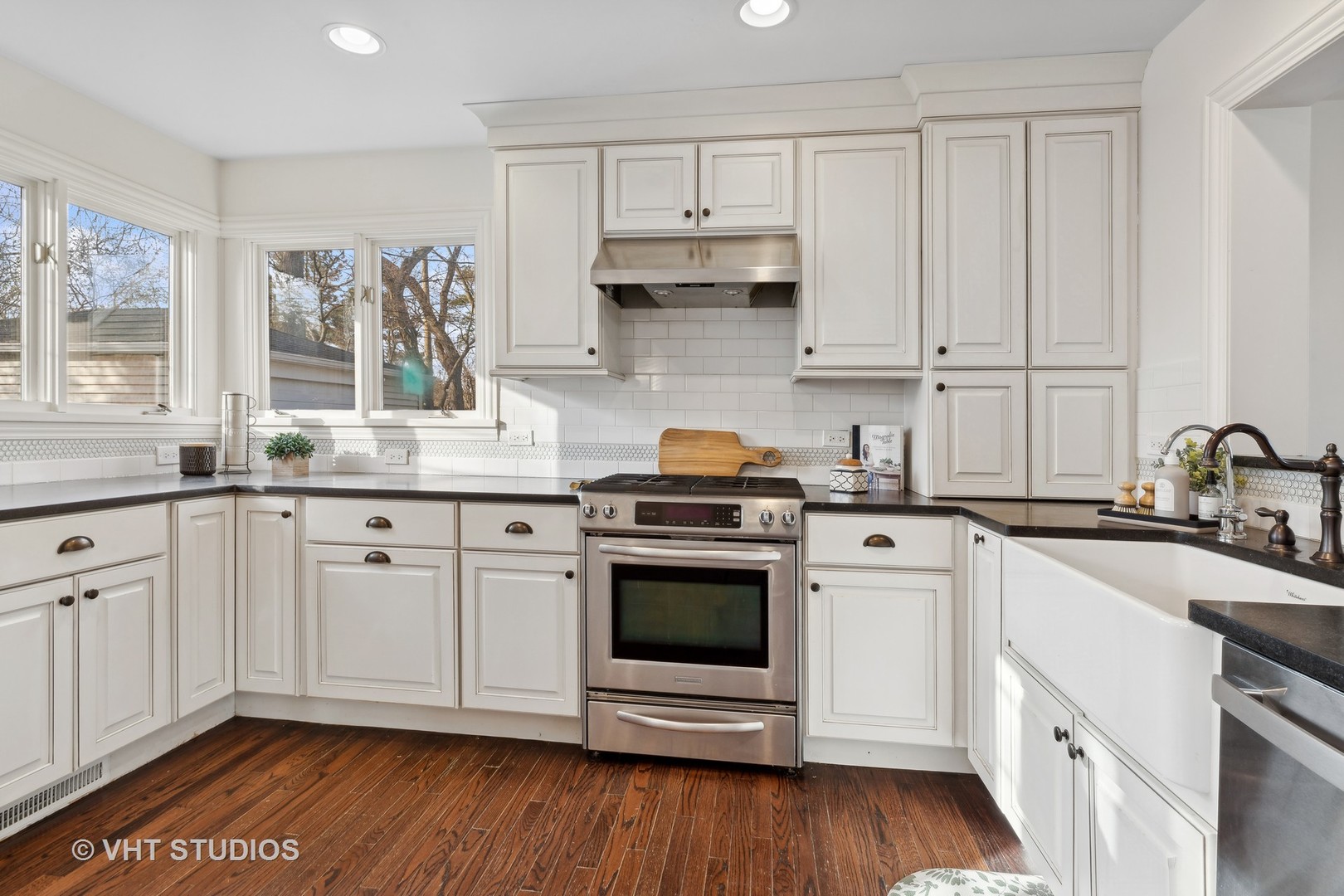 601 Long Road Glenview, IL 60025 - Photo 9 of 27 a kitchen with stainless steel appliances granite countertop a sink a stove and white cabinets with wooden floor