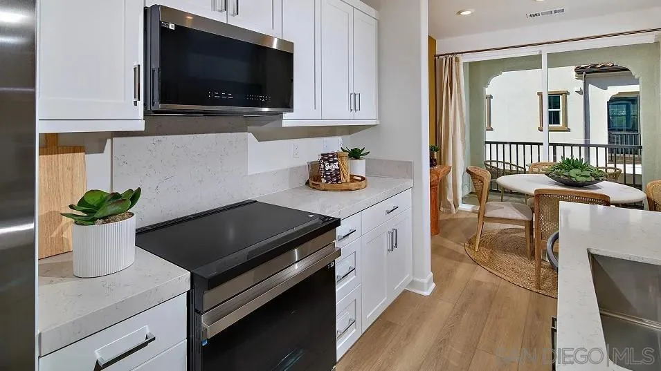 1412 Mountain Laurel Road San Marcos, CA 92078 - Photo 4 of 16 a kitchen with a sink and a stove top oven