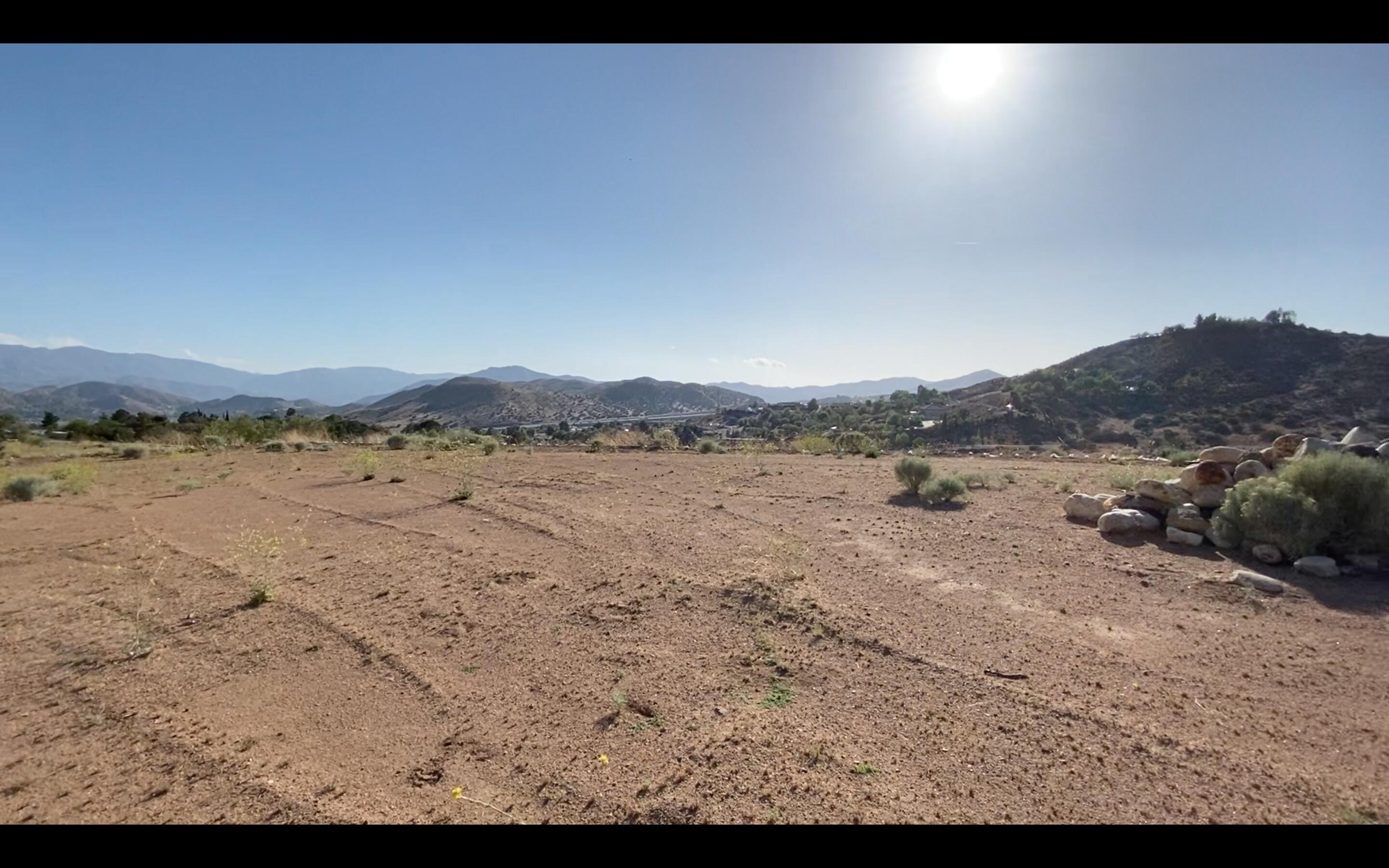 33673 White Feather Road, Unit SPC 25 Acton, CA 93510 - Photo 2 of 5 a view of a lake with beach and mountain view