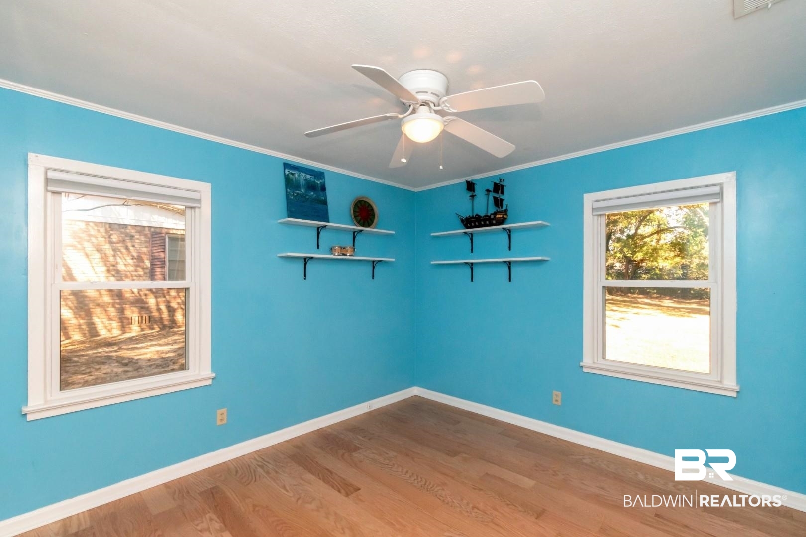 1321 Rainbow Drive West Mobile, AL 36693 - Photo 32 of 48 Empty room featuring crown molding, light wood-type flooring, and ceiling fan