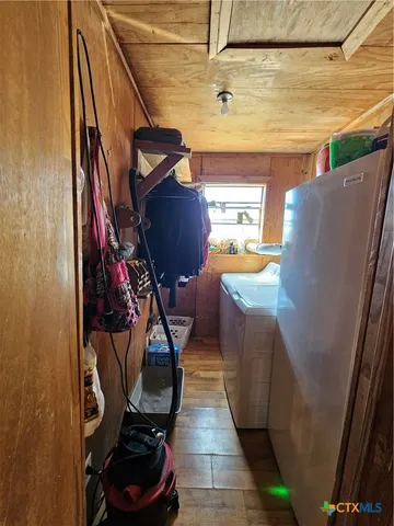 a view of a garage with wooden chairs