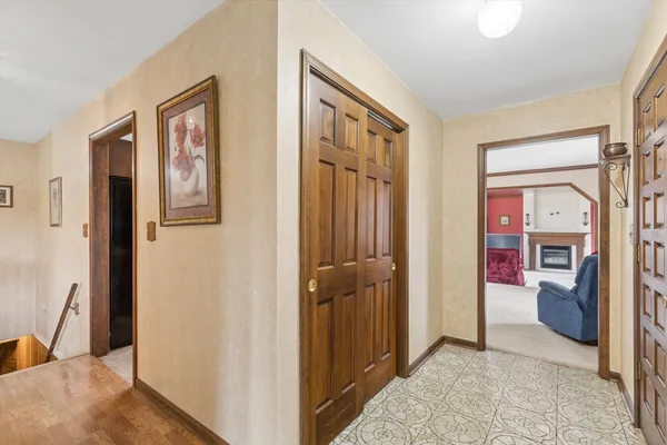 a view of a hallway with bathroom and front door