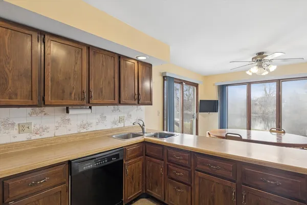 a kitchen with stainless steel appliances granite countertop a sink a stove and cabinets