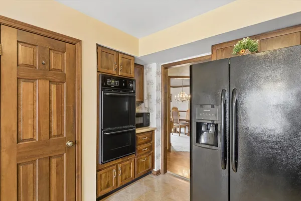 a kitchen with stainless steel appliances granite countertop a refrigerator and a refrigerator