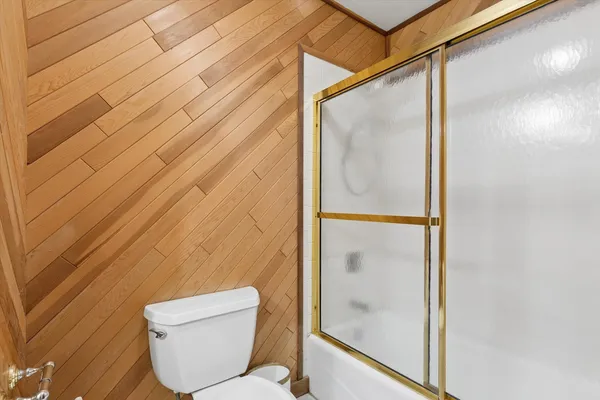 a bathroom with a toilet and a shower