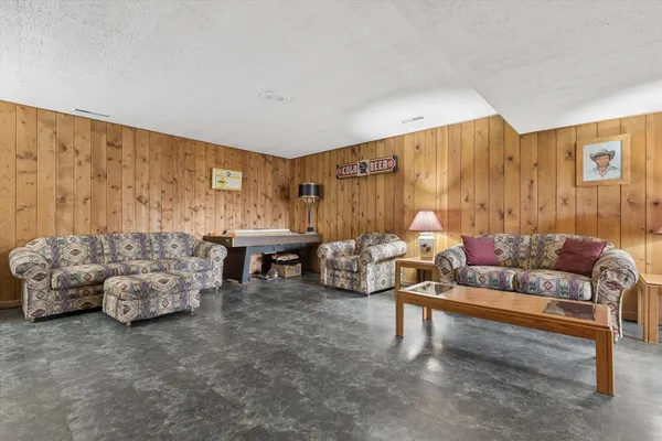a living room with furniture and a floor to ceiling window