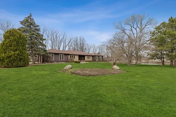 a view of house with a yard