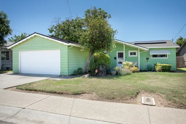 a front view of a house with garden