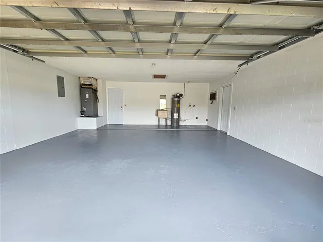 a view of an empty room with a floor to ceiling window and an outdoor space