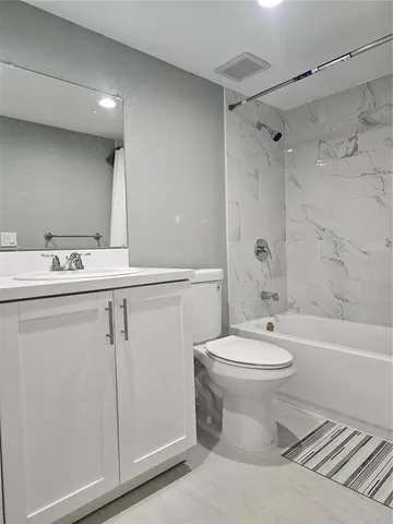 a bathroom with a sink a toilet and a bathtub