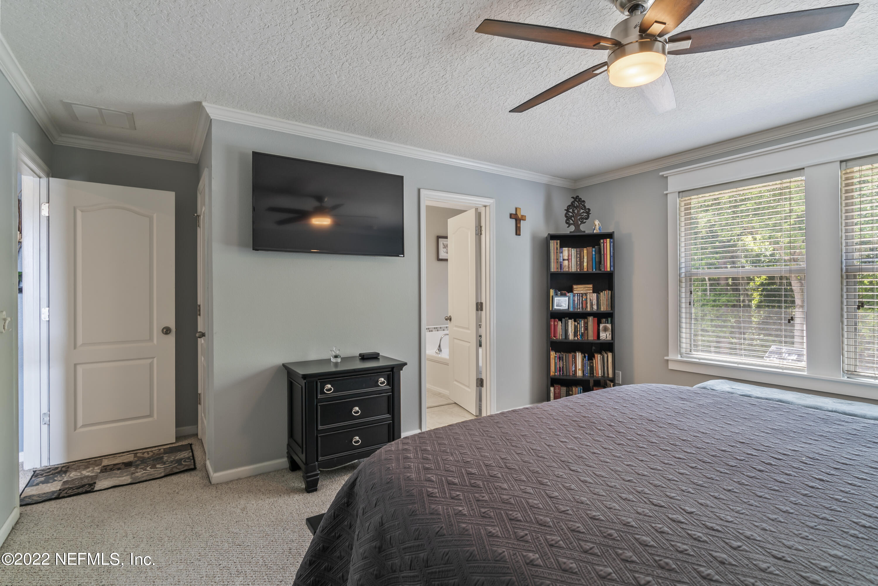 16372 Tisons Bluff Road Jacksonville, FL 32218 - Photo 23 of 51 a bedroom with a bed and a flat screen tv