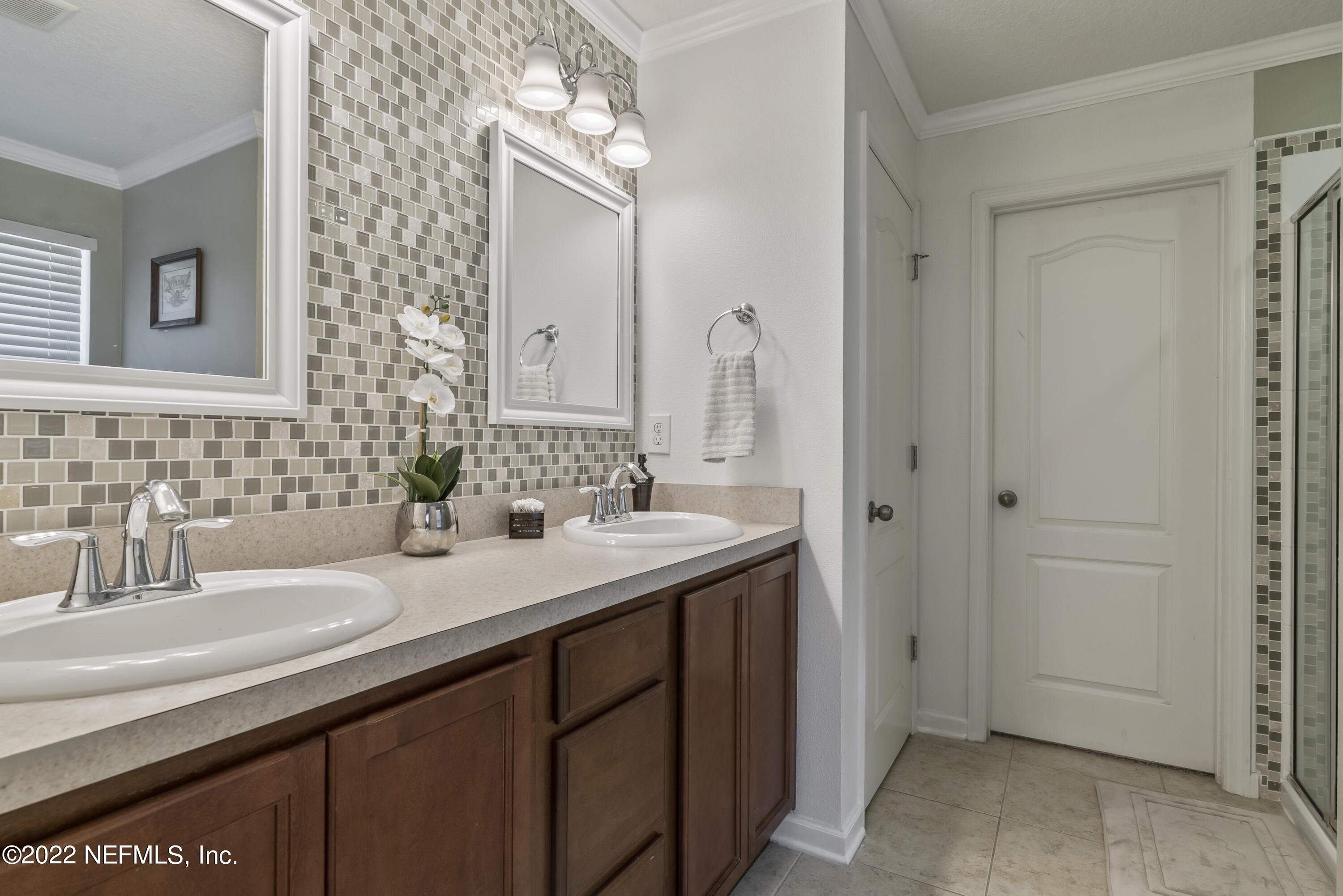 16372 Tisons Bluff Road Jacksonville, FL 32218 - Photo 25 of 51 a bathroom with a sink and a mirror