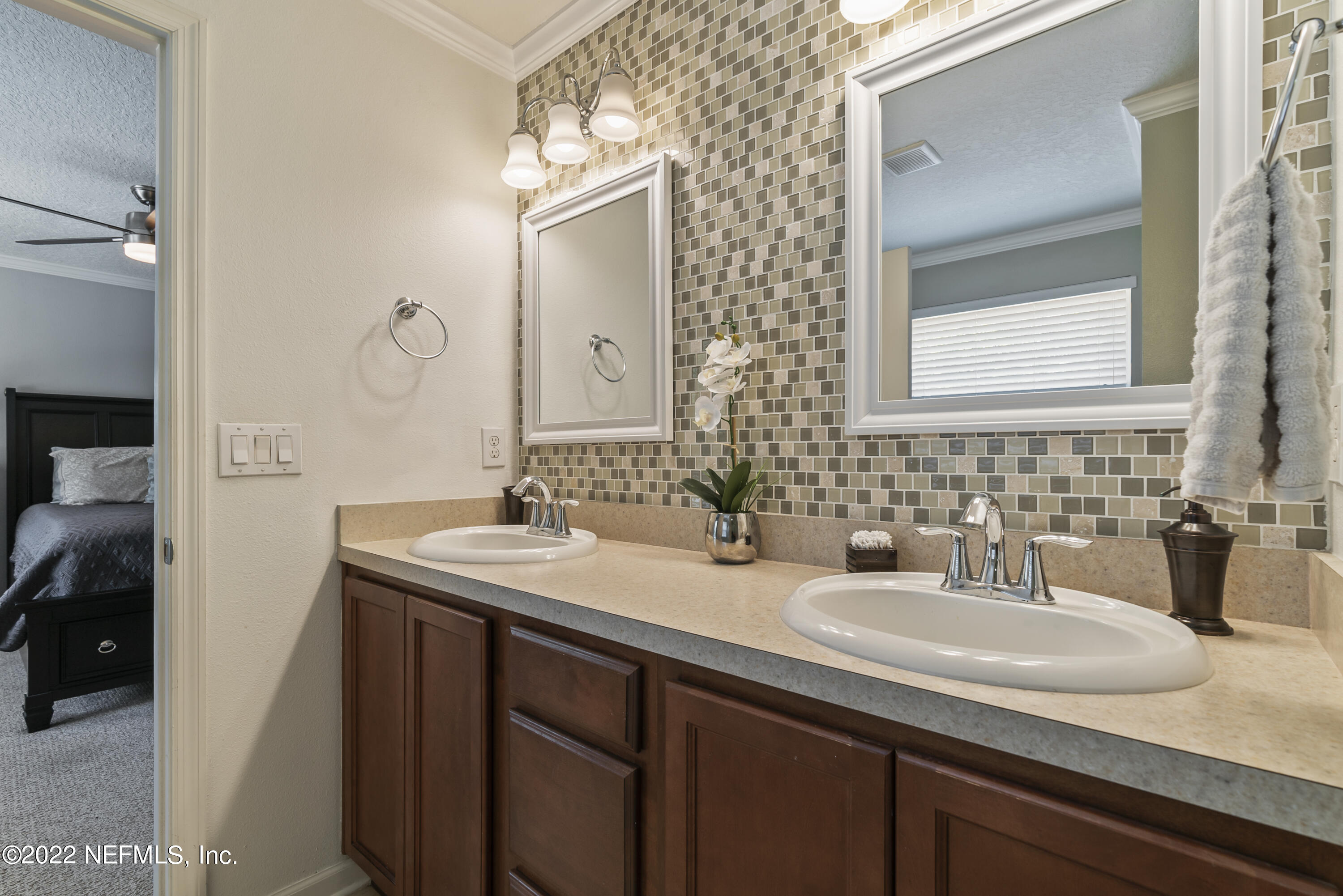 16372 Tisons Bluff Road Jacksonville, FL 32218 - Photo 28 of 51 a bathroom with a sink and two mirror