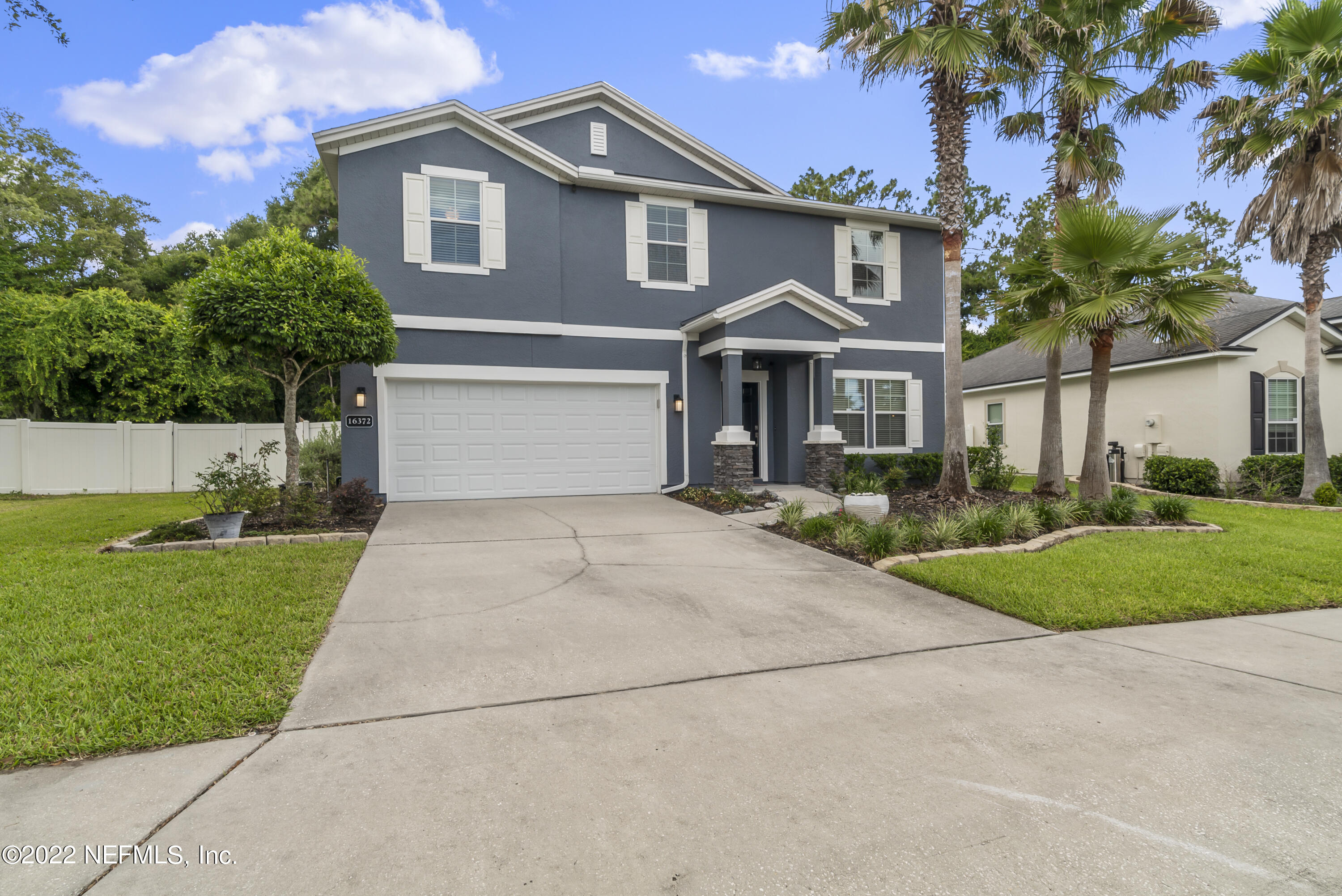 16372 Tisons Bluff Road Jacksonville, FL 32218 - Photo 3 of 51 a front view of a house with a yard and trees