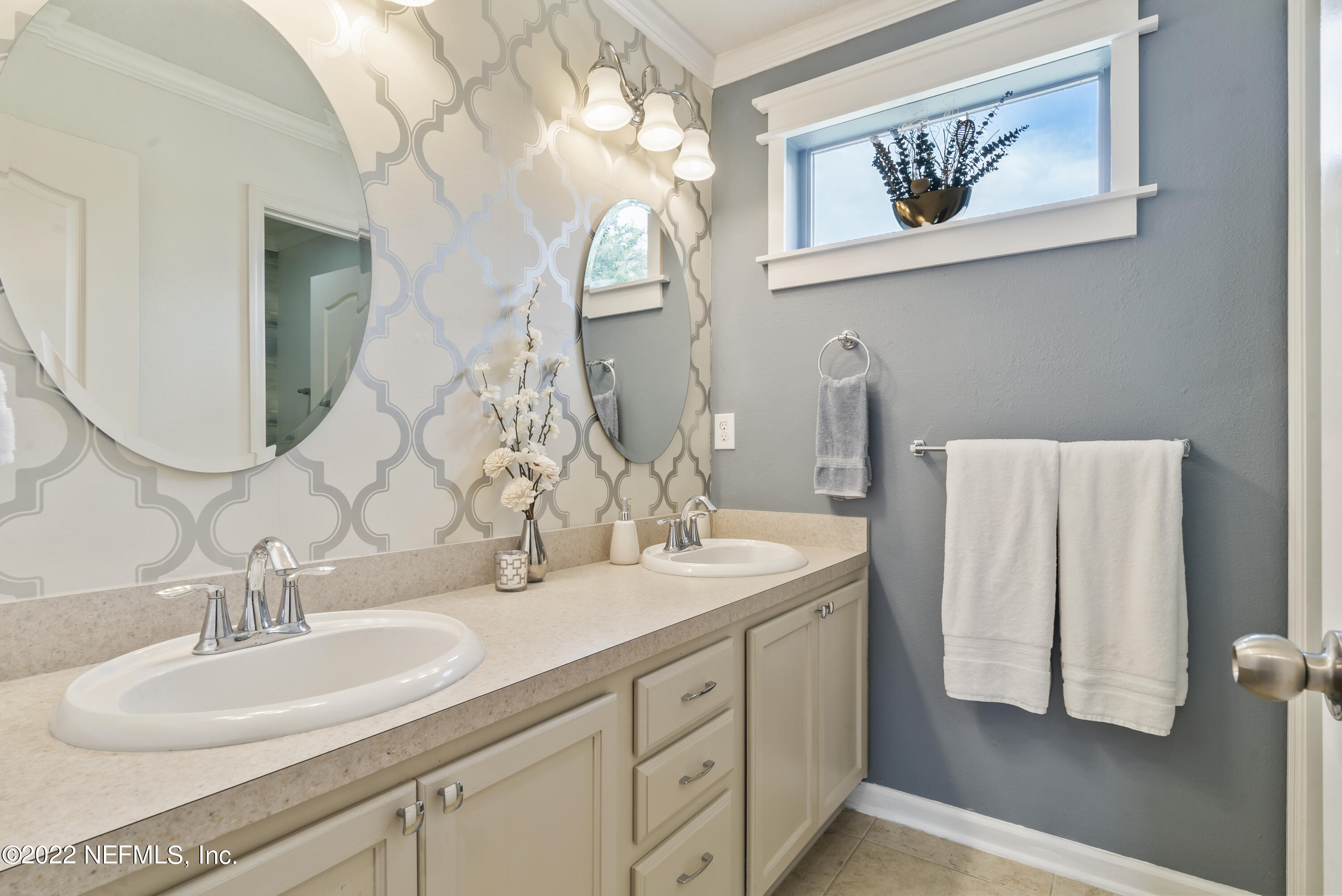 16372 Tisons Bluff Road Jacksonville, FL 32218 - Photo 34 of 51 a bathroom with a double vanity sink and a mirror