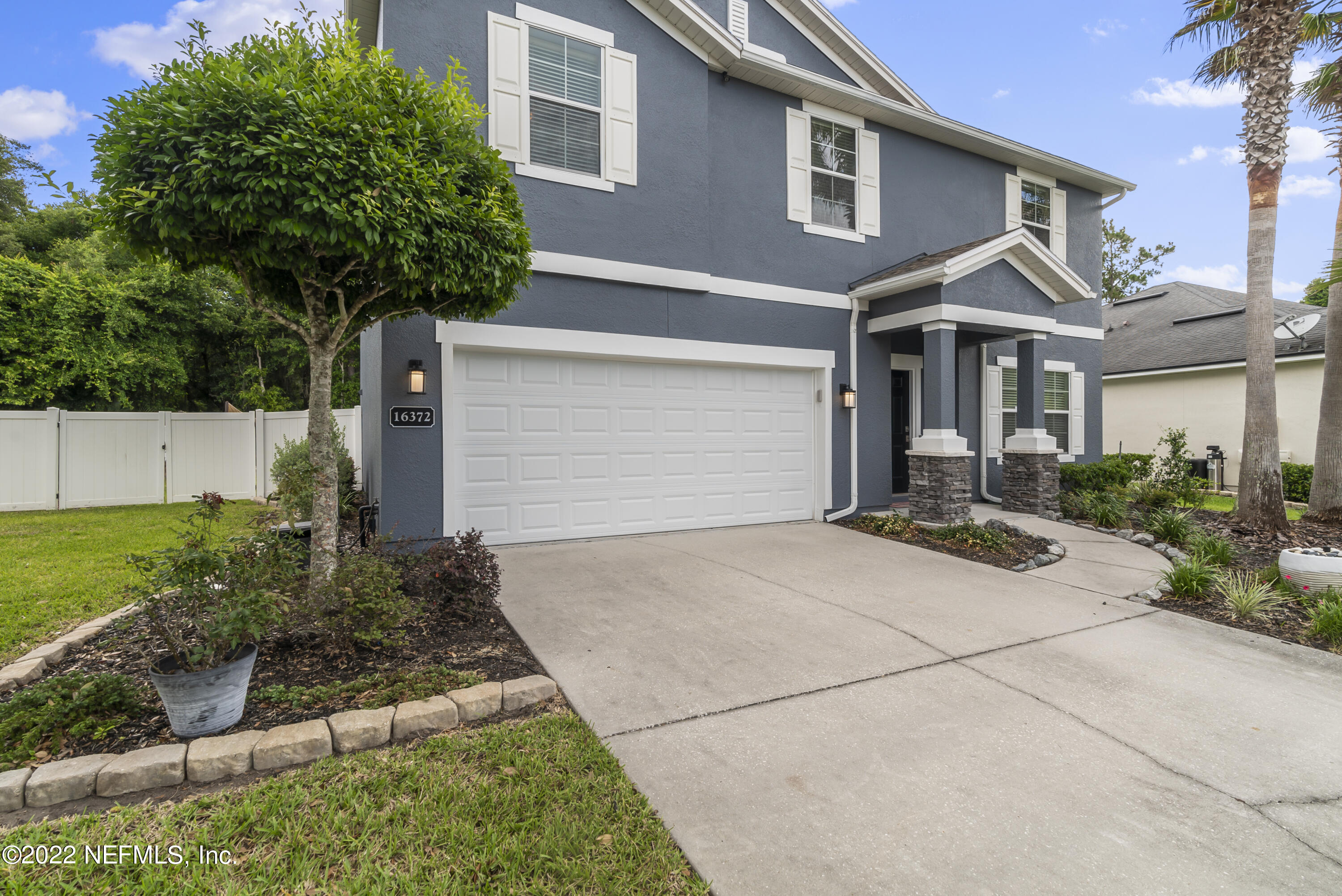 16372 Tisons Bluff Road Jacksonville, FL 32218 - Photo 4 of 51 a front view of a house with garden