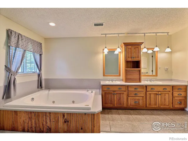a bedroom with a bed and a potted plant