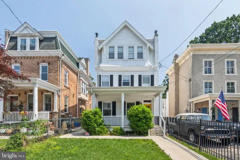 a front view of a house with yard and porch