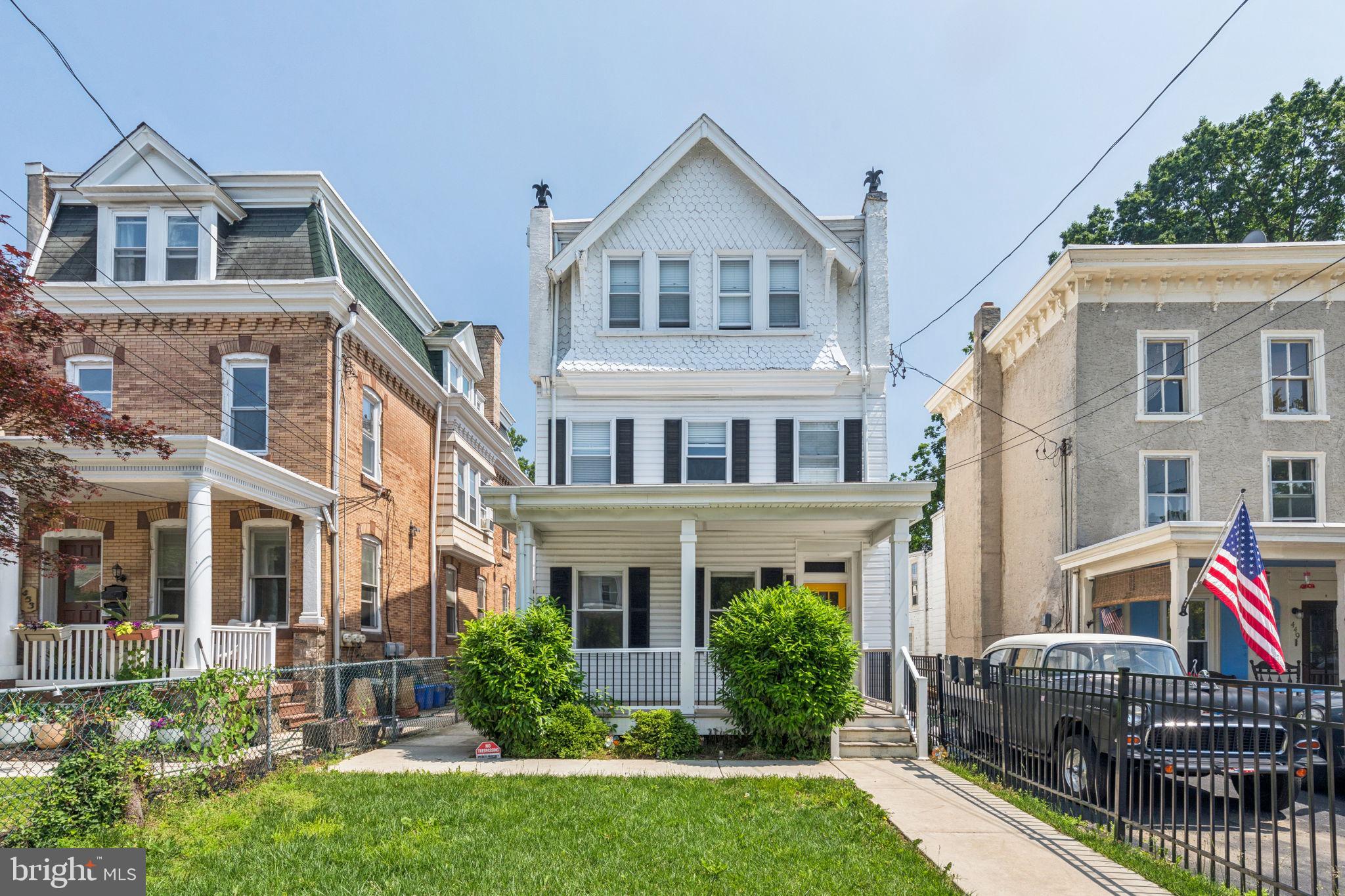 a front view of a house with yard and porch