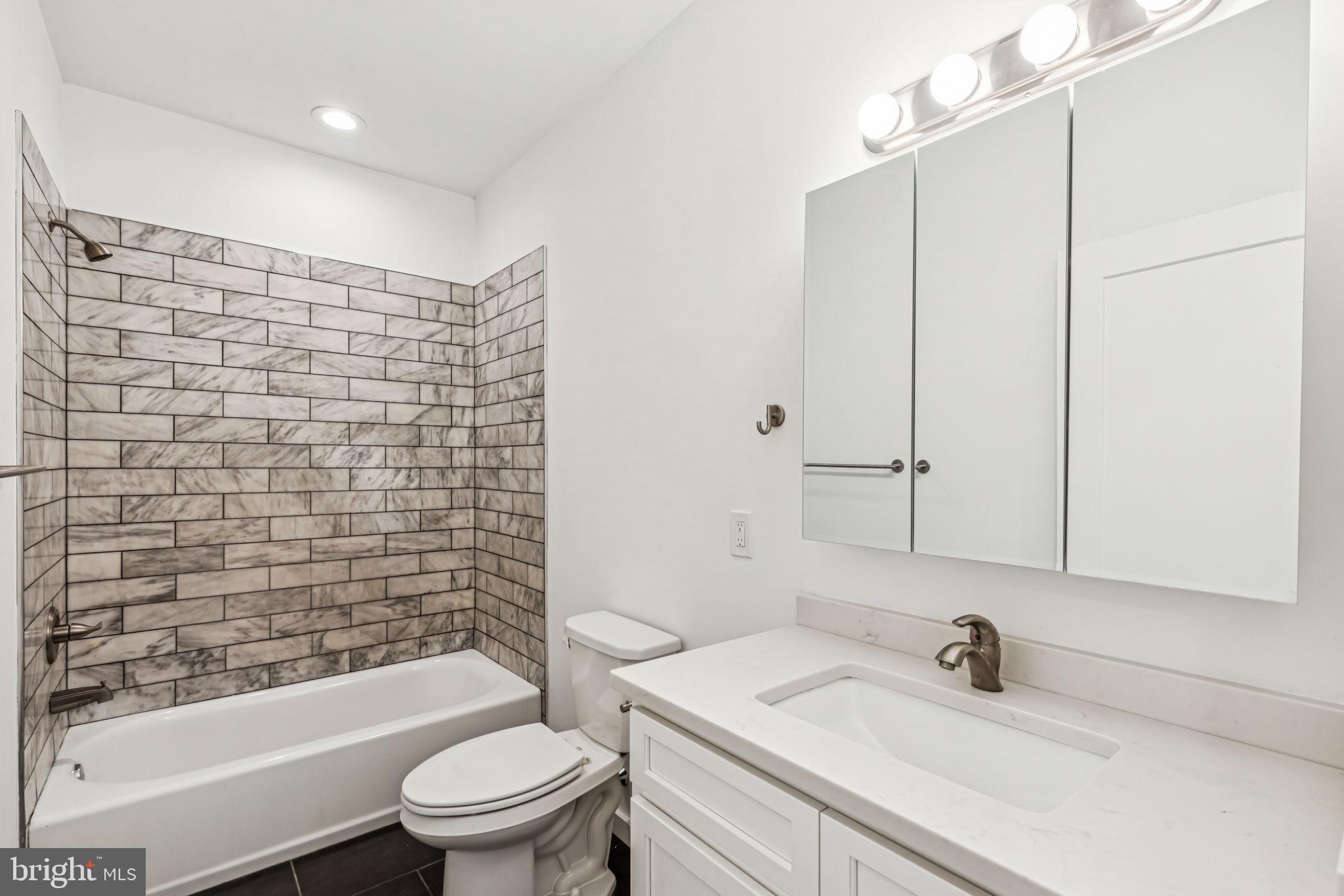 451 Green Lane Philadelphia, PA 19128 - Photo 16 of 22 a bathroom with a sink a toilet and shower