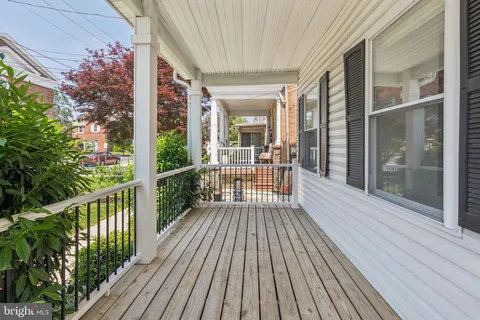 a view of a balcony with wooden floor