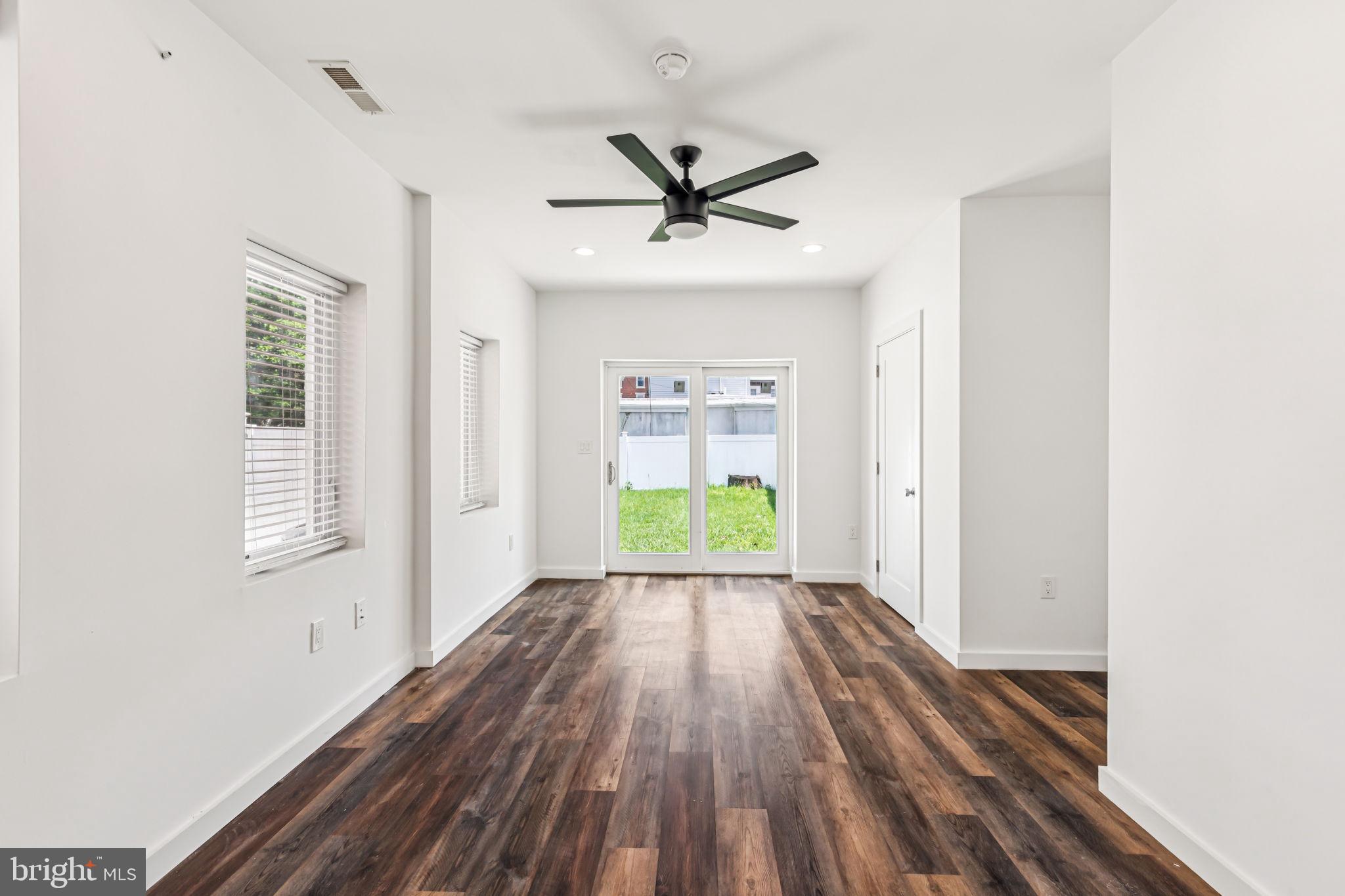 451 Green Lane Philadelphia, PA 19128 - Photo 6 of 22 a view of a big room with wooden floor a ceiling fan and windows