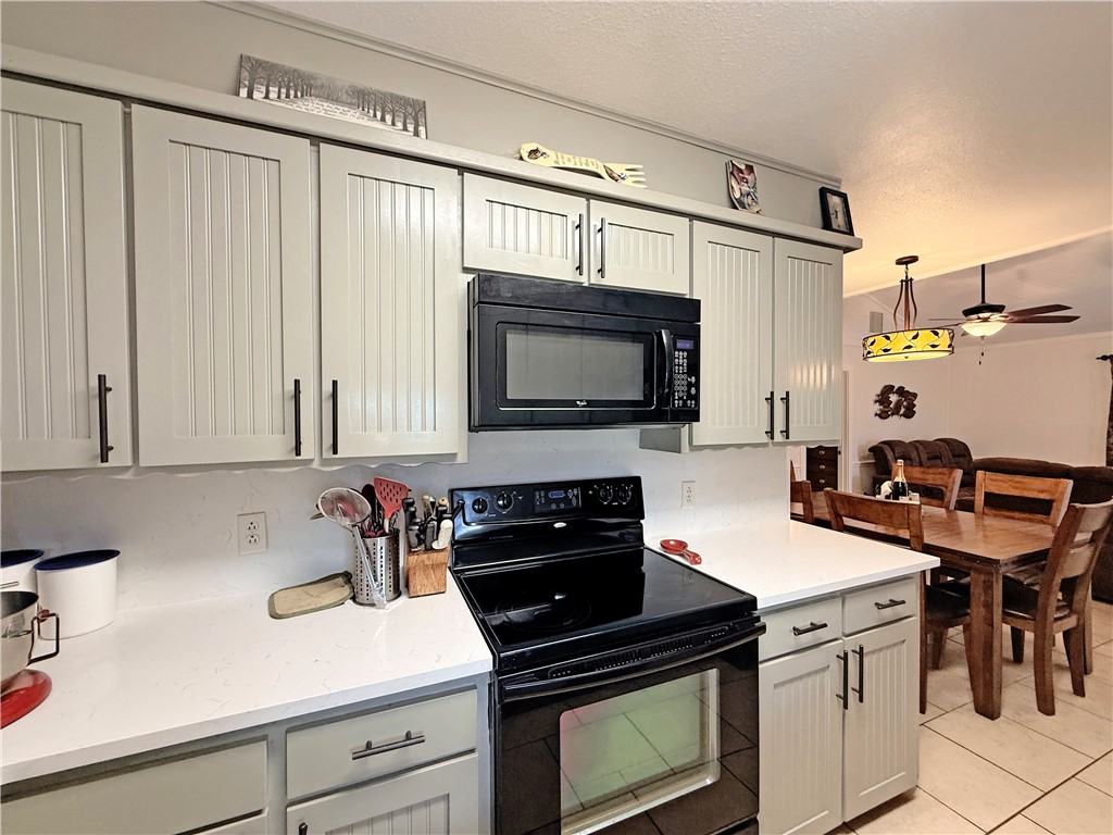 105 Copano Cove Road Rockport, TX 78382 - Photo 11 of 40 a kitchen with stainless steel appliances a stove a sink and a microwave