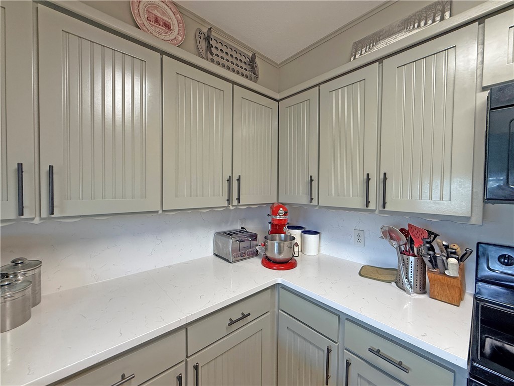 105 Copano Cove Road Rockport, TX 78382 - Photo 12 of 40 a kitchen with a sink cabinets and window