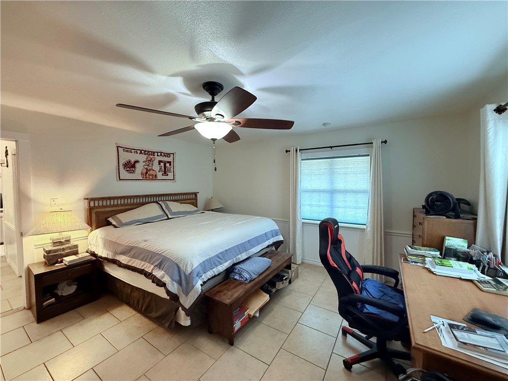 105 Copano Cove Road Rockport, TX 78382 - Photo 13 of 40 a bedroom with a bed and a window
