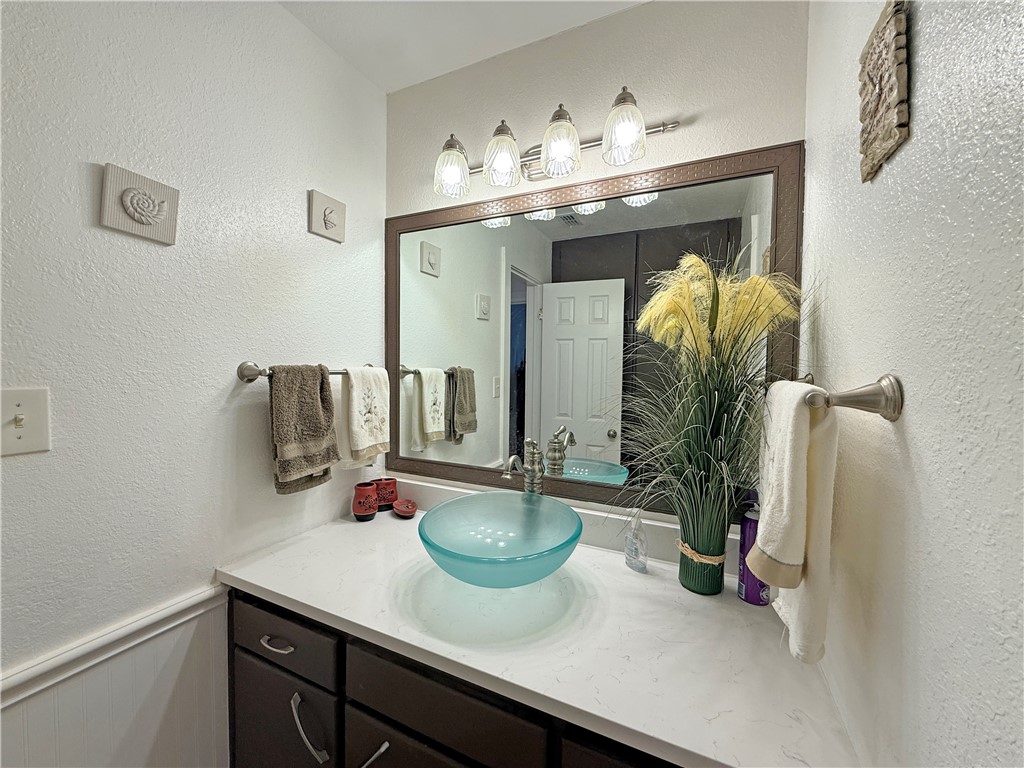 105 Copano Cove Road Rockport, TX 78382 - Photo 15 of 40 a bathroom with a sink double vanity and mirror