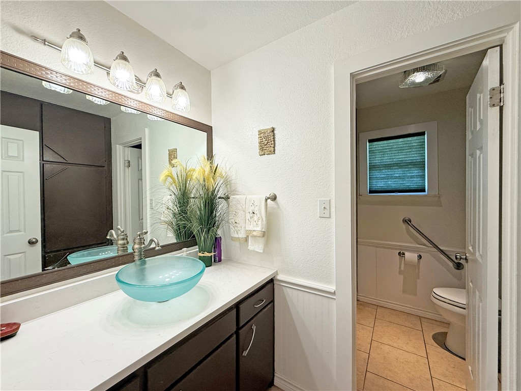 105 Copano Cove Road Rockport, TX 78382 - Photo 16 of 40 a bathroom with a sink a toilet and shower