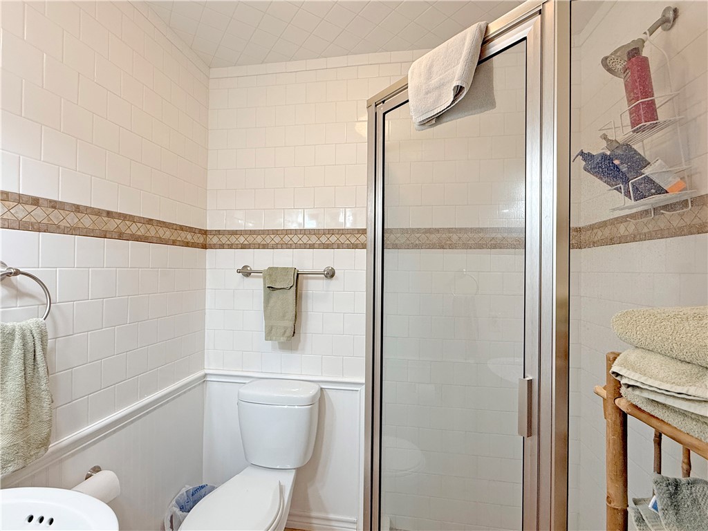 105 Copano Cove Road Rockport, TX 78382 - Photo 21 of 40 a bathroom with a shower a toilet and a sink