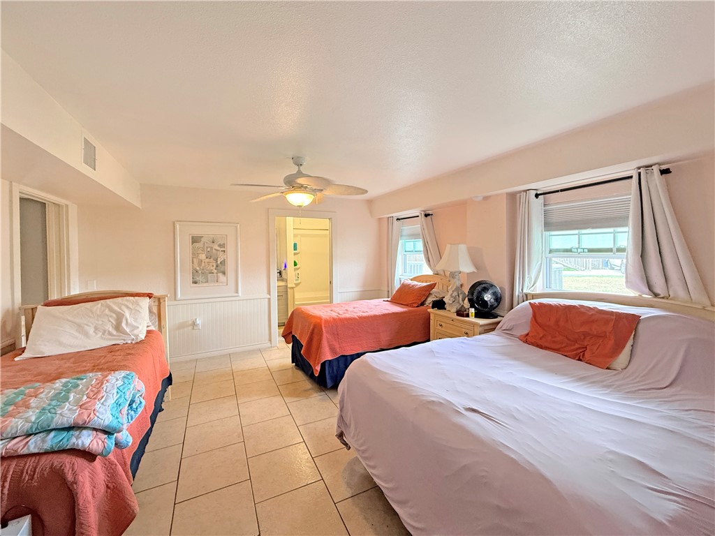 105 Copano Cove Road Rockport, TX 78382 - Photo 27 of 40 a bedroom with two beds and a couch