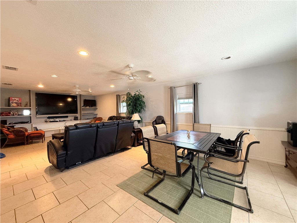105 Copano Cove Road Rockport, TX 78382 - Photo 30 of 40 a living room with furniture and a flat screen tv