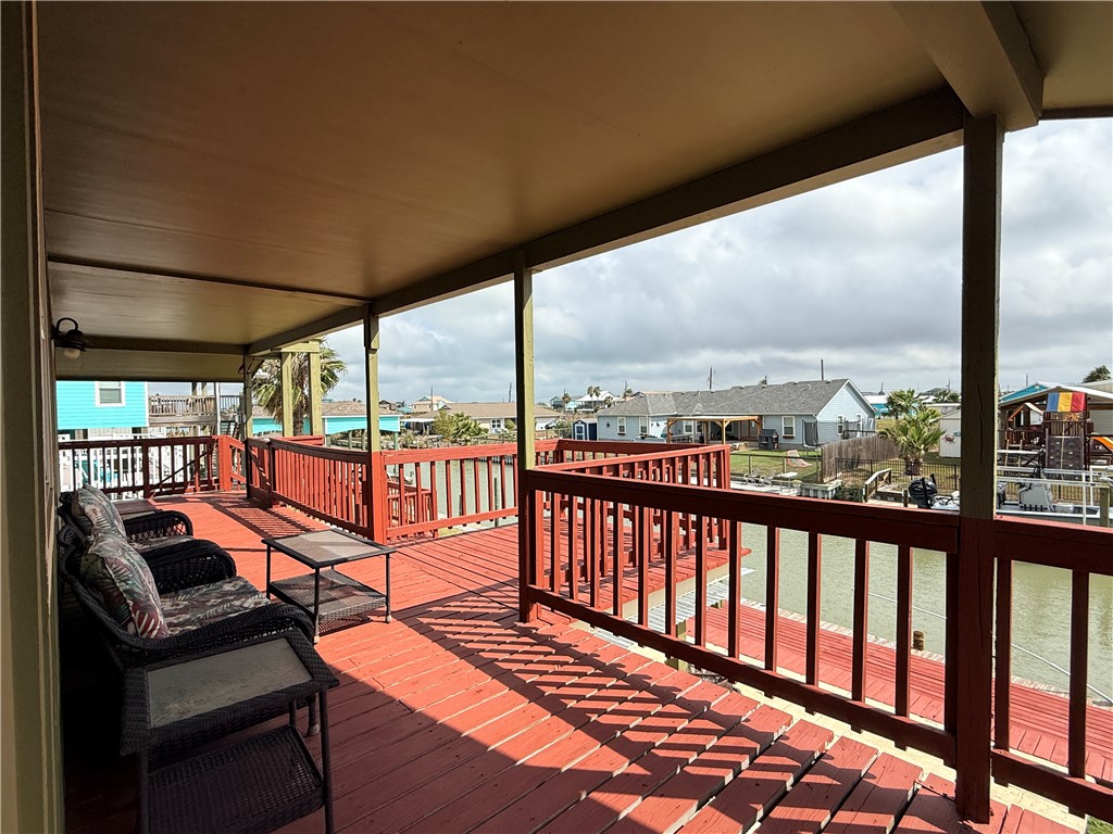 105 Copano Cove Road Rockport, TX 78382 - Photo 39 of 40 a view of a balcony with chairs and wooden floor