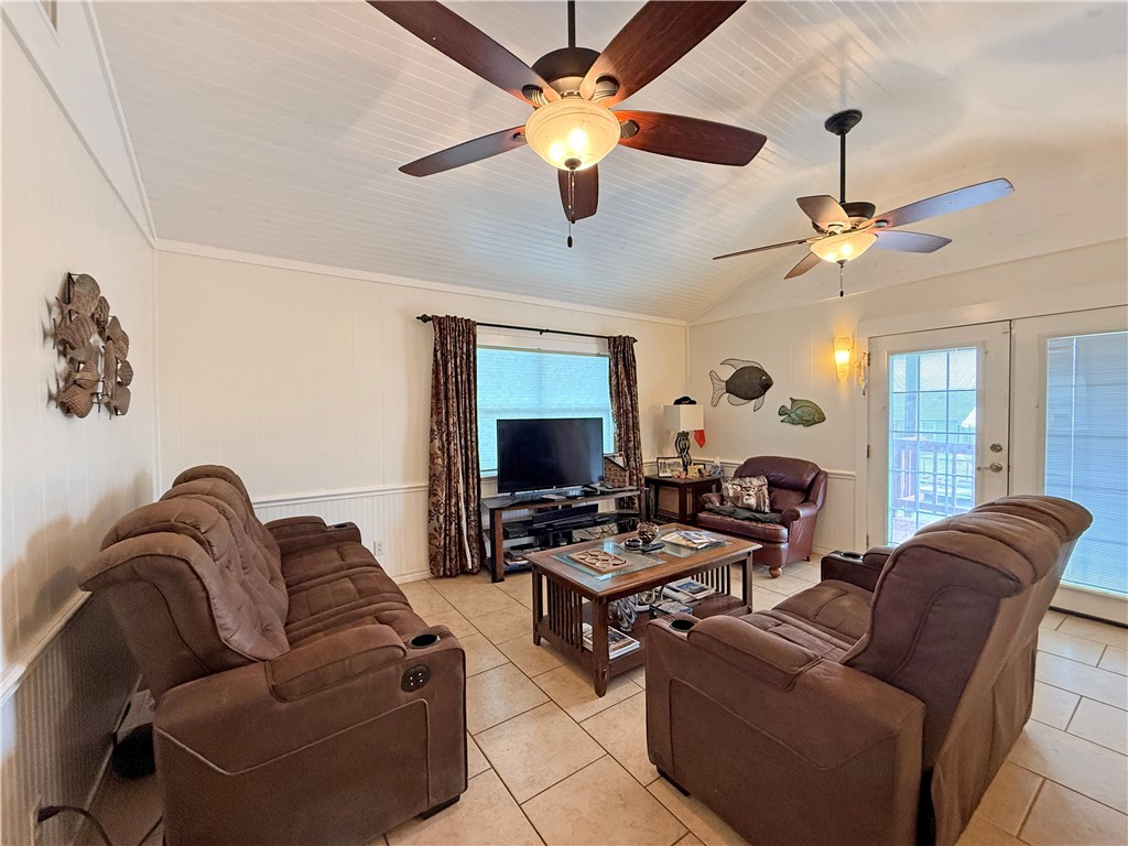 105 Copano Cove Road Rockport, TX 78382 - Photo 5 of 40 a living room with furniture a ceiling fan and a window