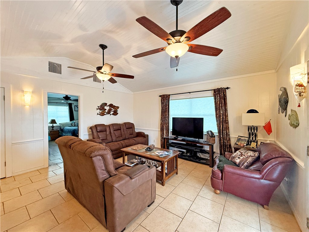 105 Copano Cove Road Rockport, TX 78382 - Photo 7 of 40 a living room with furniture and a flat screen tv