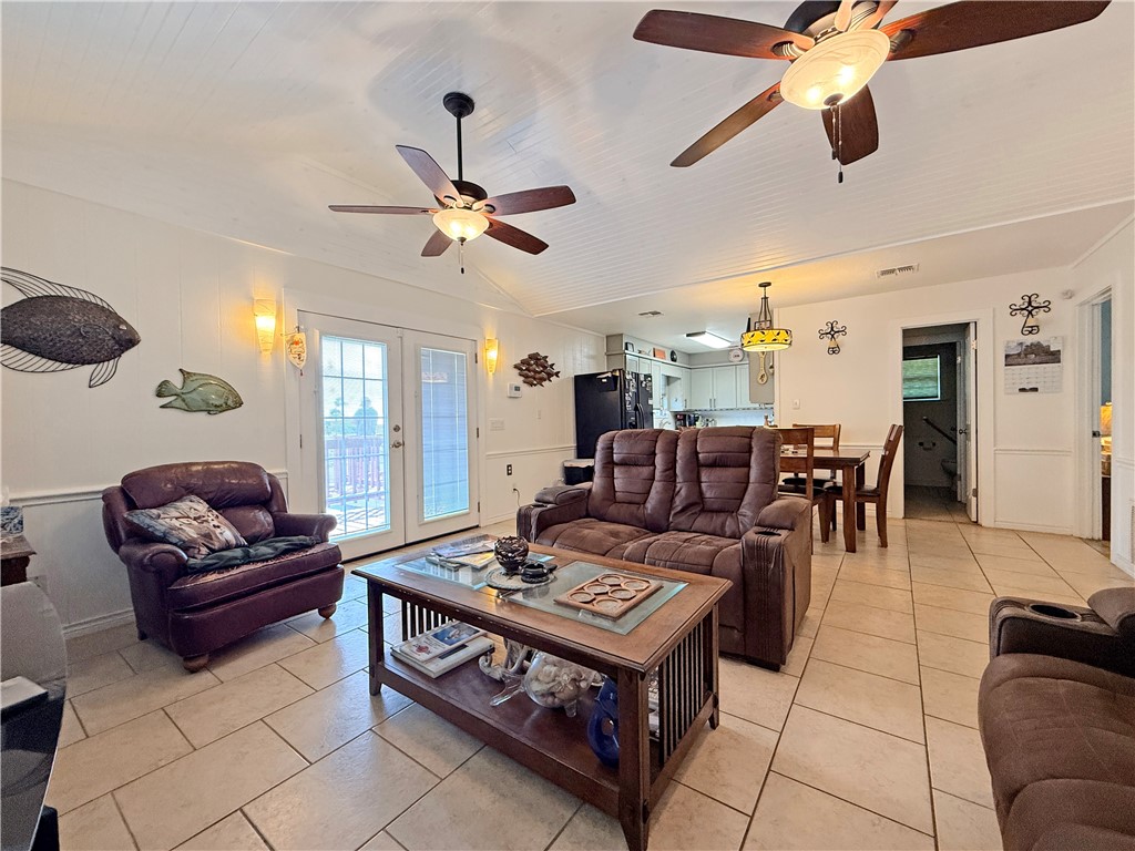 105 Copano Cove Road Rockport, TX 78382 - Photo 8 of 40 a living room with furniture a ceiling fan and a window
