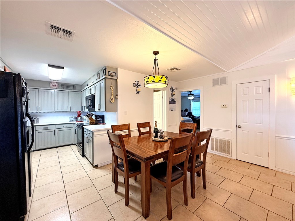 105 Copano Cove Road Rockport, TX 78382 - Photo 9 of 40 a view of a dining room with furniture and chandelier