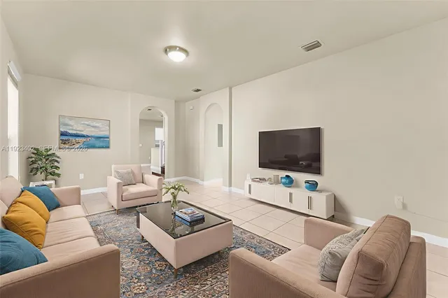 a living room with furniture and a flat screen tv