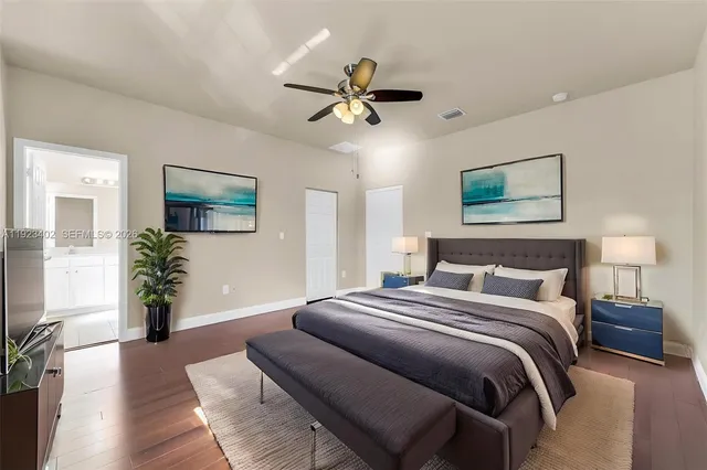 a bedroom with a large bed and a chandelier