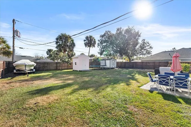 a swimming pool with outdoor seating and yard