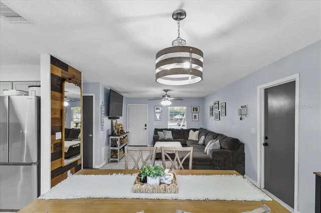 a living room with furniture and a chandelier