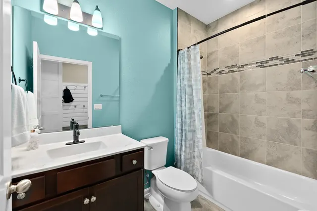 a view of hallway with livingroom and wooden floor