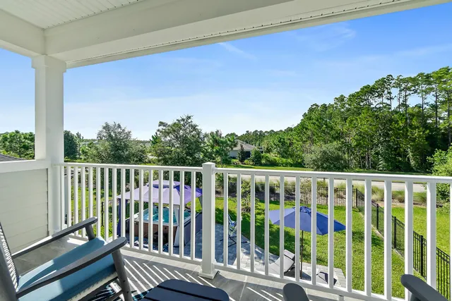 a view of a patio with a table chairs under an umbrella