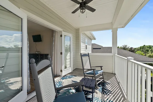 a view of yard from deck with patio